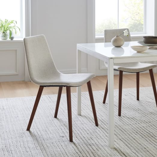 white dining chairs with dark wood legs