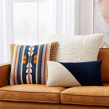 set of three throw pillows with white, blue, and baja design