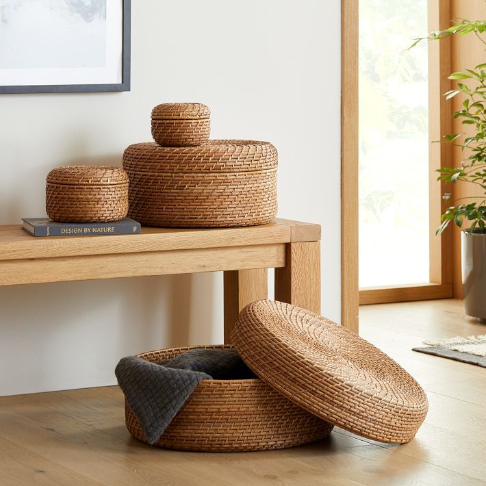 Close-up of lidded wicker storage boxes on bamboo stool Stock