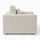 Side view of cream-colored sofa armrest and back showing clean fabric