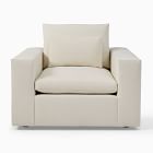 Cream-colored armchair with large back cushion and wide arms, front view