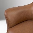 Close-up of the top edge/armrest junction of the brown leather chair.