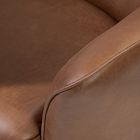 Seat cushion of the brown leather chair with stitching along the edge.