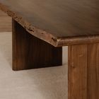Close-up of the top edge and corner of the wooden table, highlighting rough edges and natural imperfections.