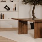 Close view of the wooden tabletop edge and one leg, showing natural wood grain and finish.