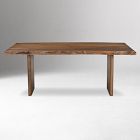 Another full view of the wooden table, showing its length and two sturdy legs.