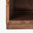 Interior corner and joint of a wooden nightstand showing shelf base