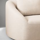 Close-up of rounded armrest and seat of a beige sofa