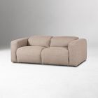 Beige three-seat sofa with small cushions against a plain white background.