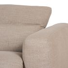 Close-up of beige sofa arm with fabric texture.