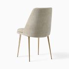 Beige upholstered chair from behind with slim wooden legs.