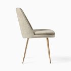 Beige upholstered chair viewed from side with wooden legs.