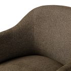 Close-up of armrest and curved back of brown upholstered chair