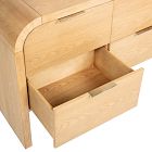 Open wooden drawer pulled out showing inner drawer space on light wood dresser