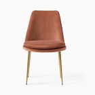 Orange terracotta upholstered chair with wooden legs.
