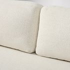 Close-up of two back cushions of a beige sofa.