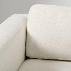 Close-up of two sofa cushions with visible seam and texture.