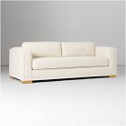 Cream/ivory sofa with cushions and wooden feet, full view.