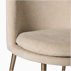Close-up of beige curved chair seat and fabric texture.