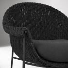 Close-up of woven wicker pattern on armrest of chair