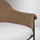 Close-up of woven wicker detail at chair arm and pillow