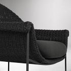 Side view of wicker chair with cushion, metal legs