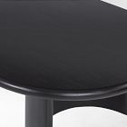 Top corner of a dark oval coffee table showing smooth finish and curved edge.