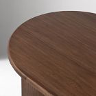 Close-up of a round wooden table top showing wood grain.