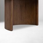 Dark wood curved leg and side panel of a table.