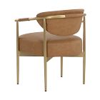 Rear perspective of a tan upholstered chair with a curved back and gold metal frame.