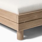Close-up of bed leg and corner joint in light wood, mattress edge visible