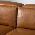 Close-up of cushions meeting seam on brown leather sofa