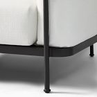 White sofa leg and underside of black metal frame