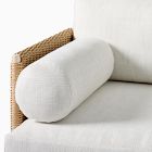 Close-up of cylindrical white bolster and plush white cushion