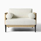 White cushioned loveseat with wicker sides and black legs