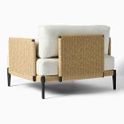 Back view of wicker armchair with white cushions