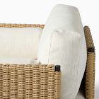 Close-up of woven rattan armrest and cushion edge
