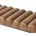 Row of brown tufted leather cushions forming a long bench.