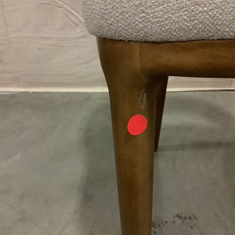 Red circular tag on a chair leg