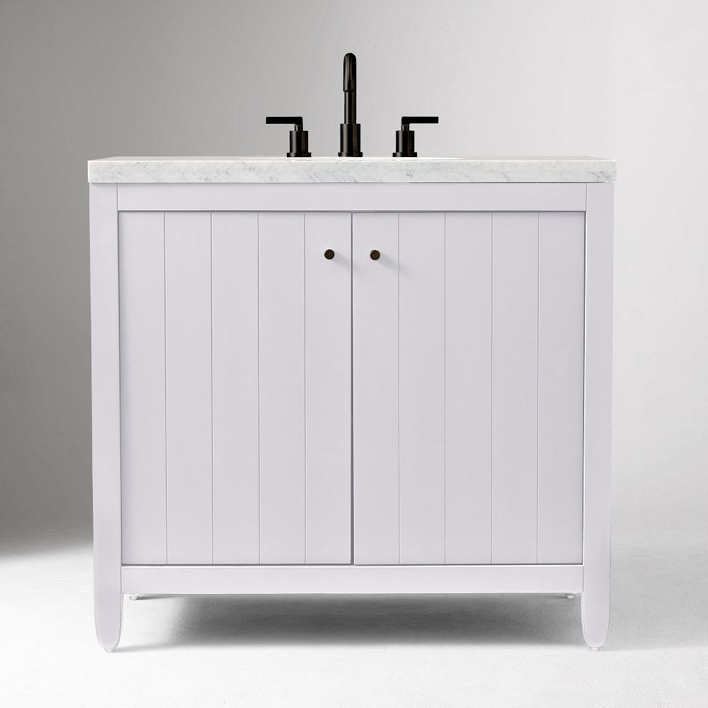 Front view of white vanity with marble top and faucet